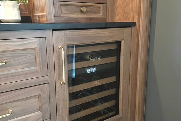 Living Room Wet Bar beverage fridge in natural wood with gold accents