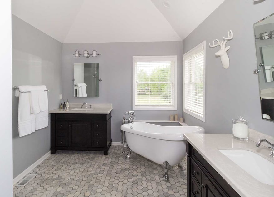 Bathroom remodel with a modern design style and a claw footed stand-alone tub in the middle of the corner