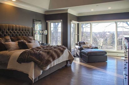 Master bedroom with a breathtaking decor, cathedral ceiling, and floor to ceiling windows