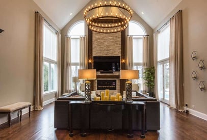 Home office with a large round chandelier suspended above the desk