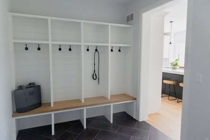 Front mudroom with lockers and hooks for hanging/storing coats, shoes, and backpacks