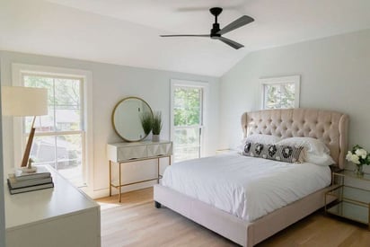 Master bedroom with a black, 3 blade ceiling fan, white bed set, and an elegant design