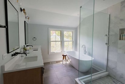 Full master bathroom with a double vanity, stand alone tub, and a walk-in shower