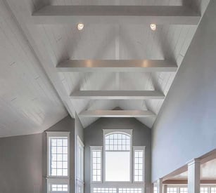 Cathedral ceiling with exposed cross trusses that have can lights built in