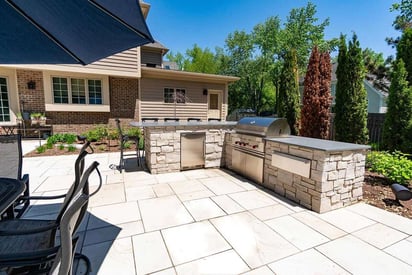 Outdoor kitchen attached to a stone absorbent patio