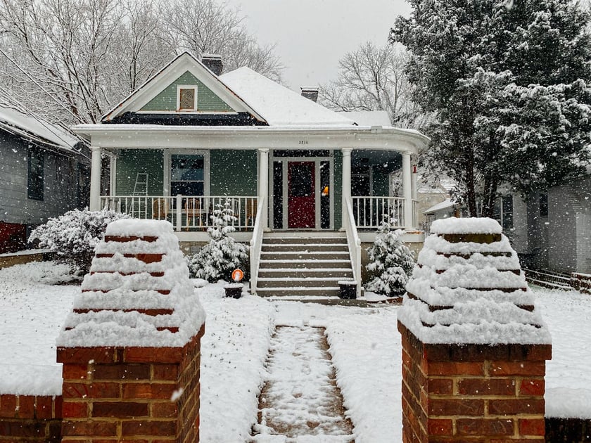 Street view photo of a home in the snow that was properly prepared by winterizing